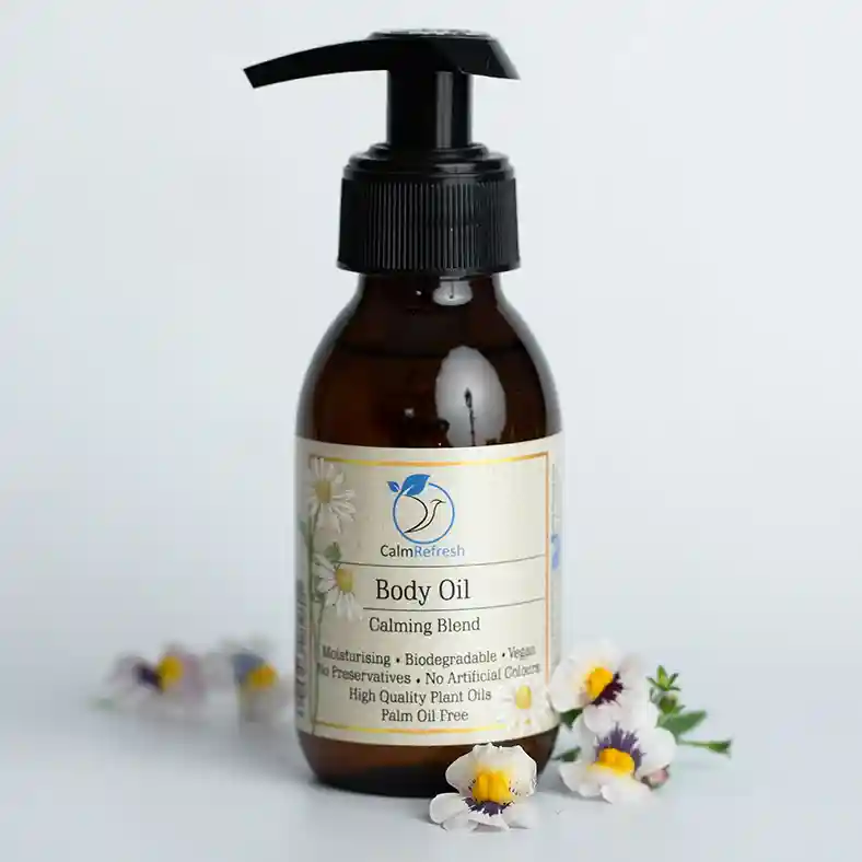 Calming Body Oil with chamomile flowers around it