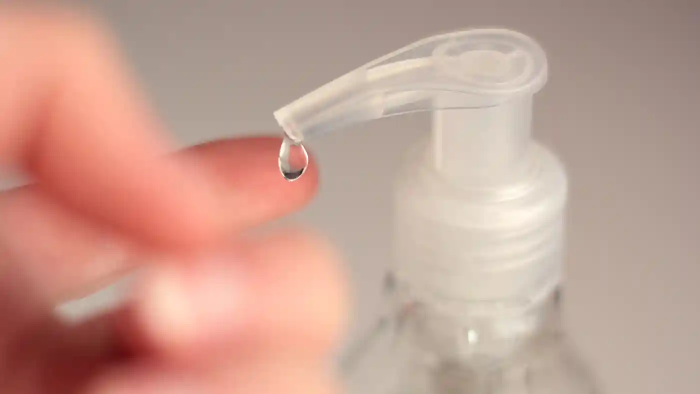 Drop of sanitiser from pump on hand