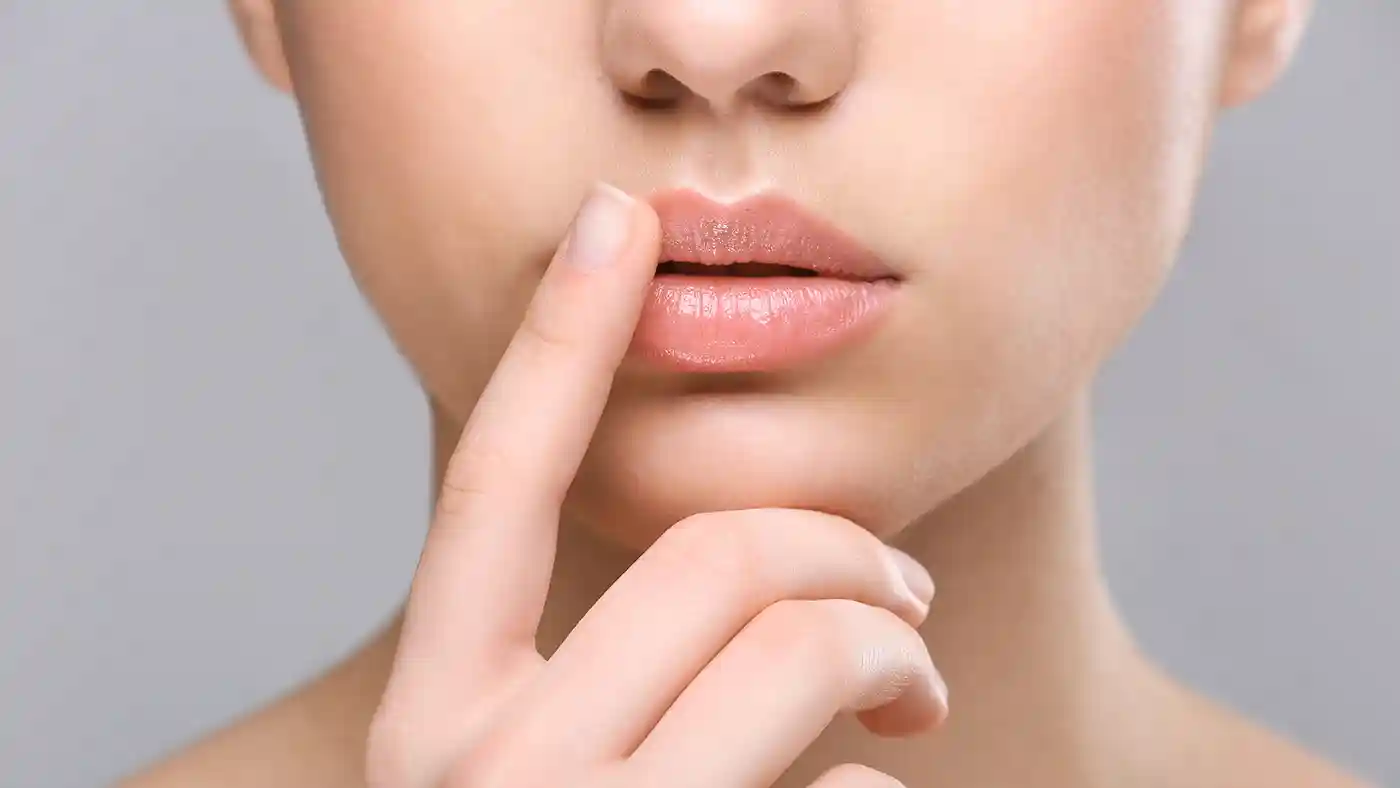 Lady touching lip with finger