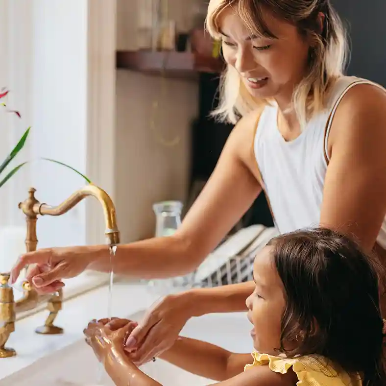 Mother and daughter washing hands