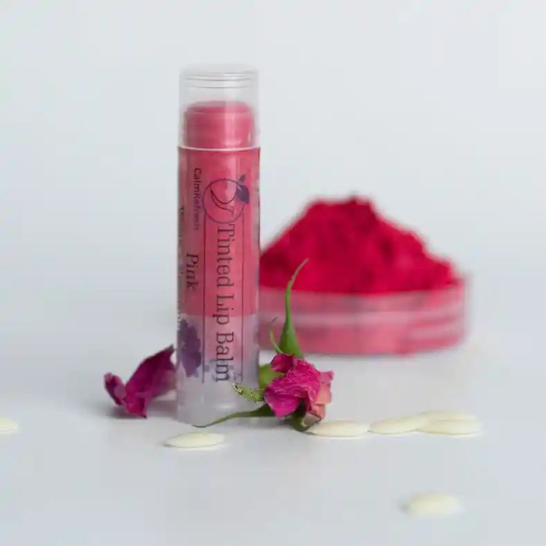 Pink Lip Balm with mica powder in background and dried roses in front